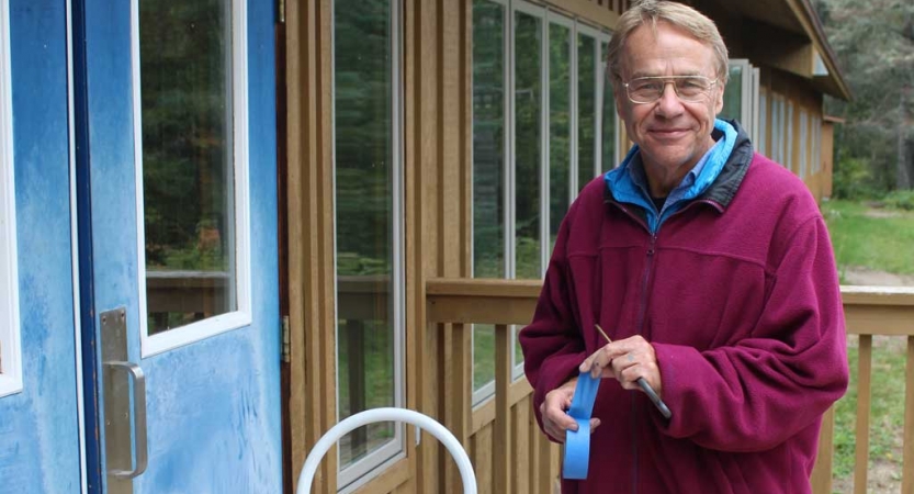 A person uses blue tape during a service project with Outward Bound.